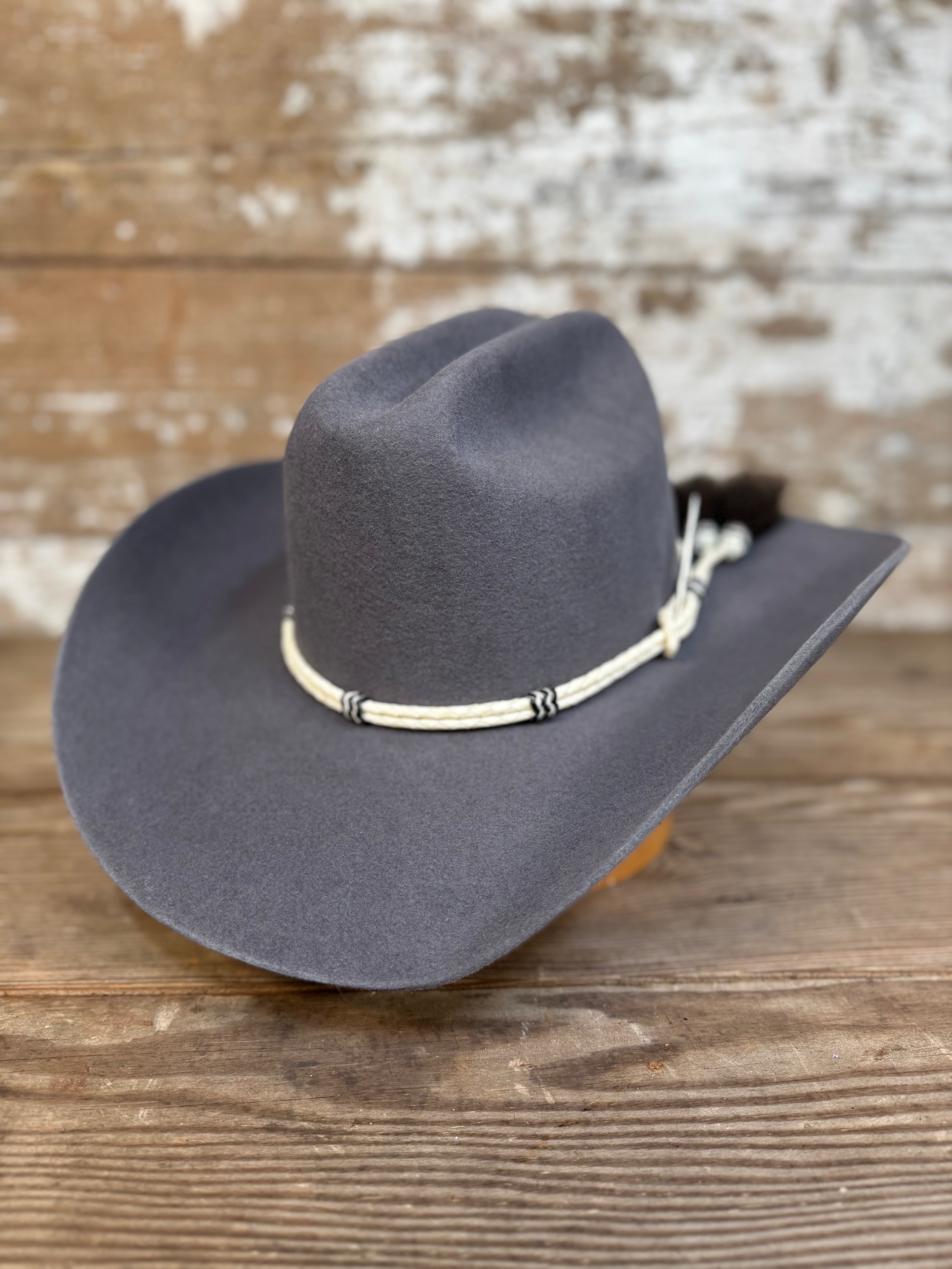 Decent Trouble charcoal felt cowboy hat with rawhide band, tassel, and toothpick detail.