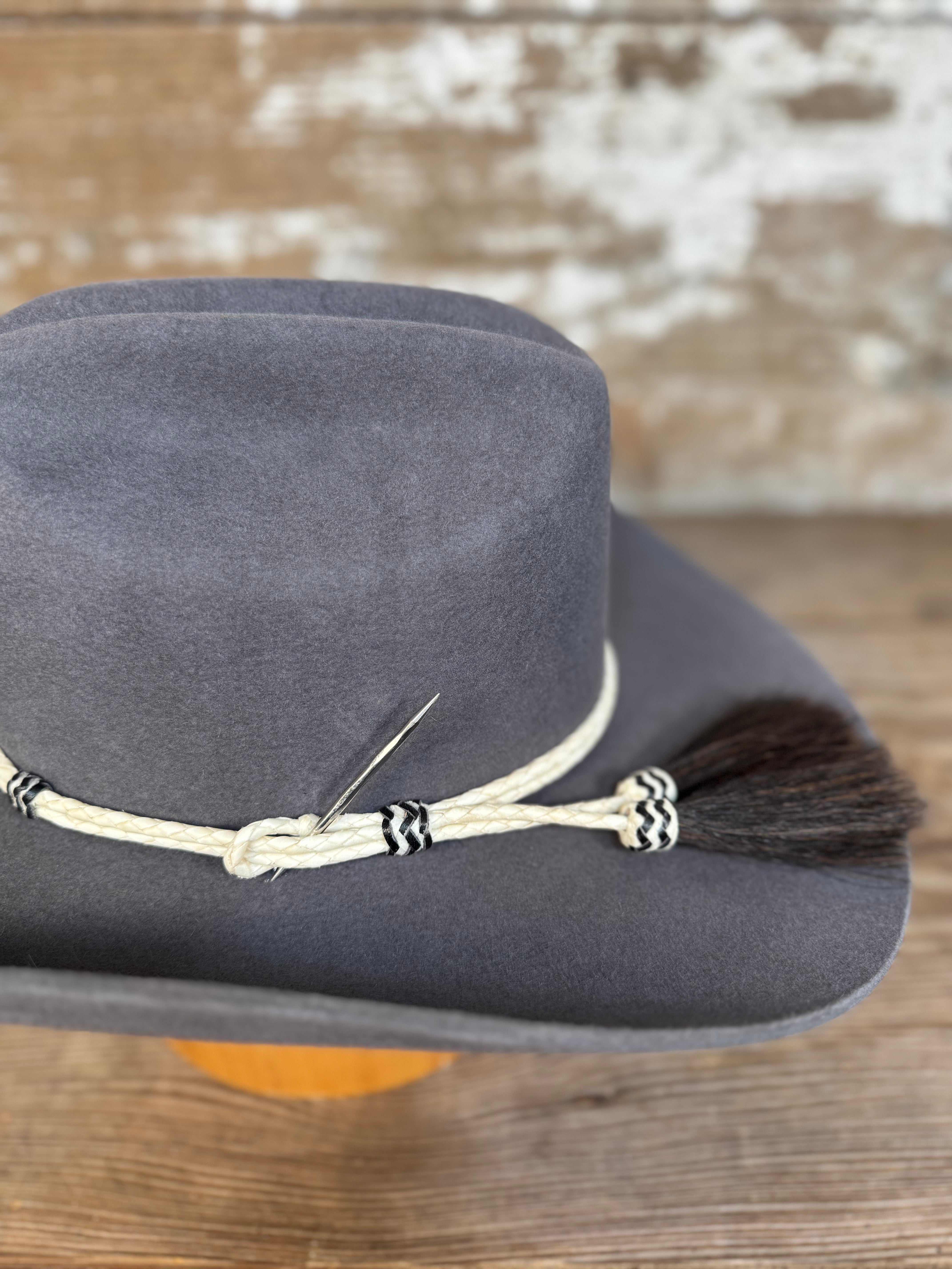 Detail view of Decent Trouble charcoal felt cowboy hat with rawhide band, tassel, and toothpick detail.