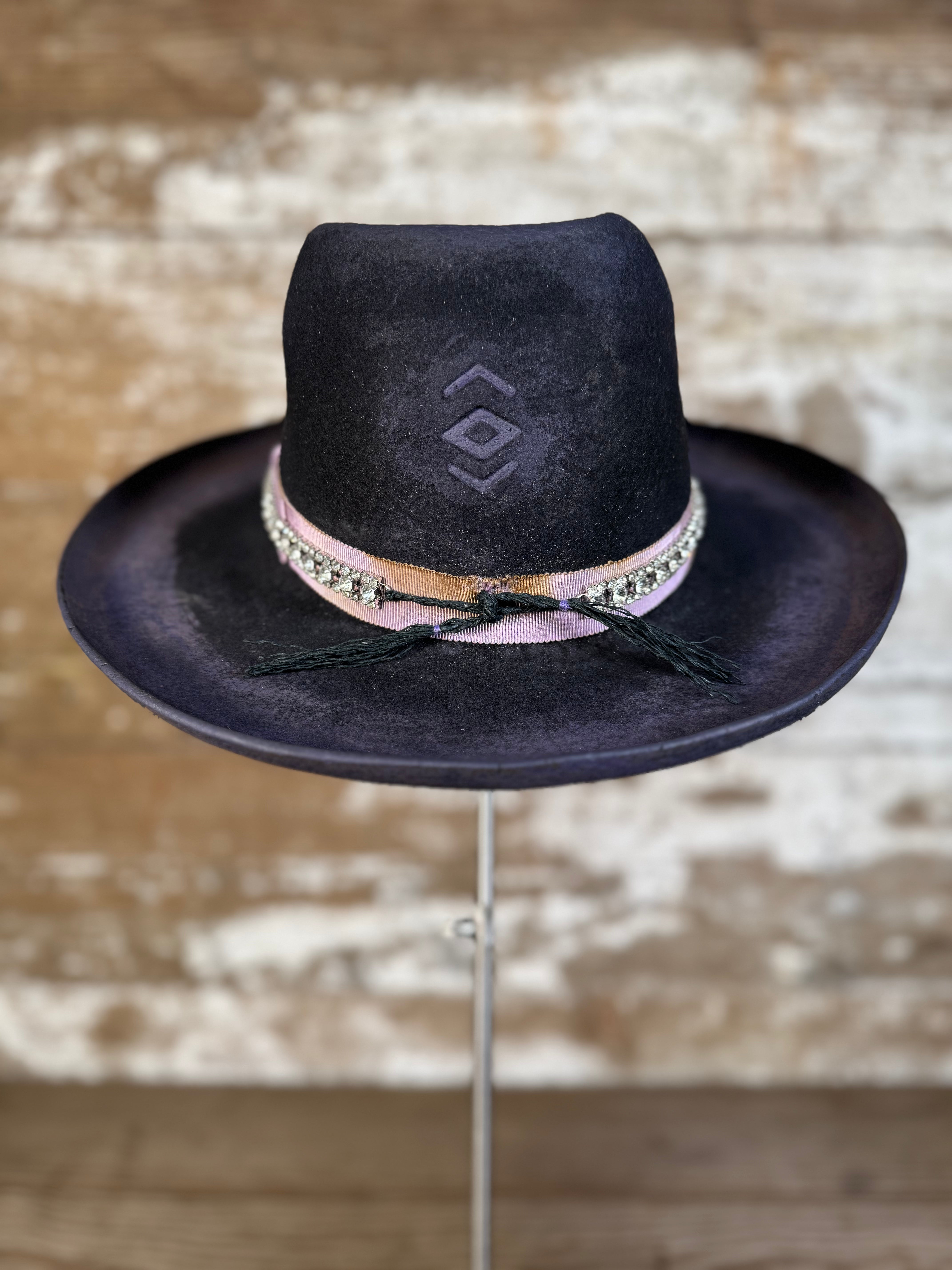 Back view of weathered violet-charcoal felt Gus hat with pencil curl brim, lilac petersham grosgrain ribbon, rhinestone band, hand stitching, and diamond brand mark.
