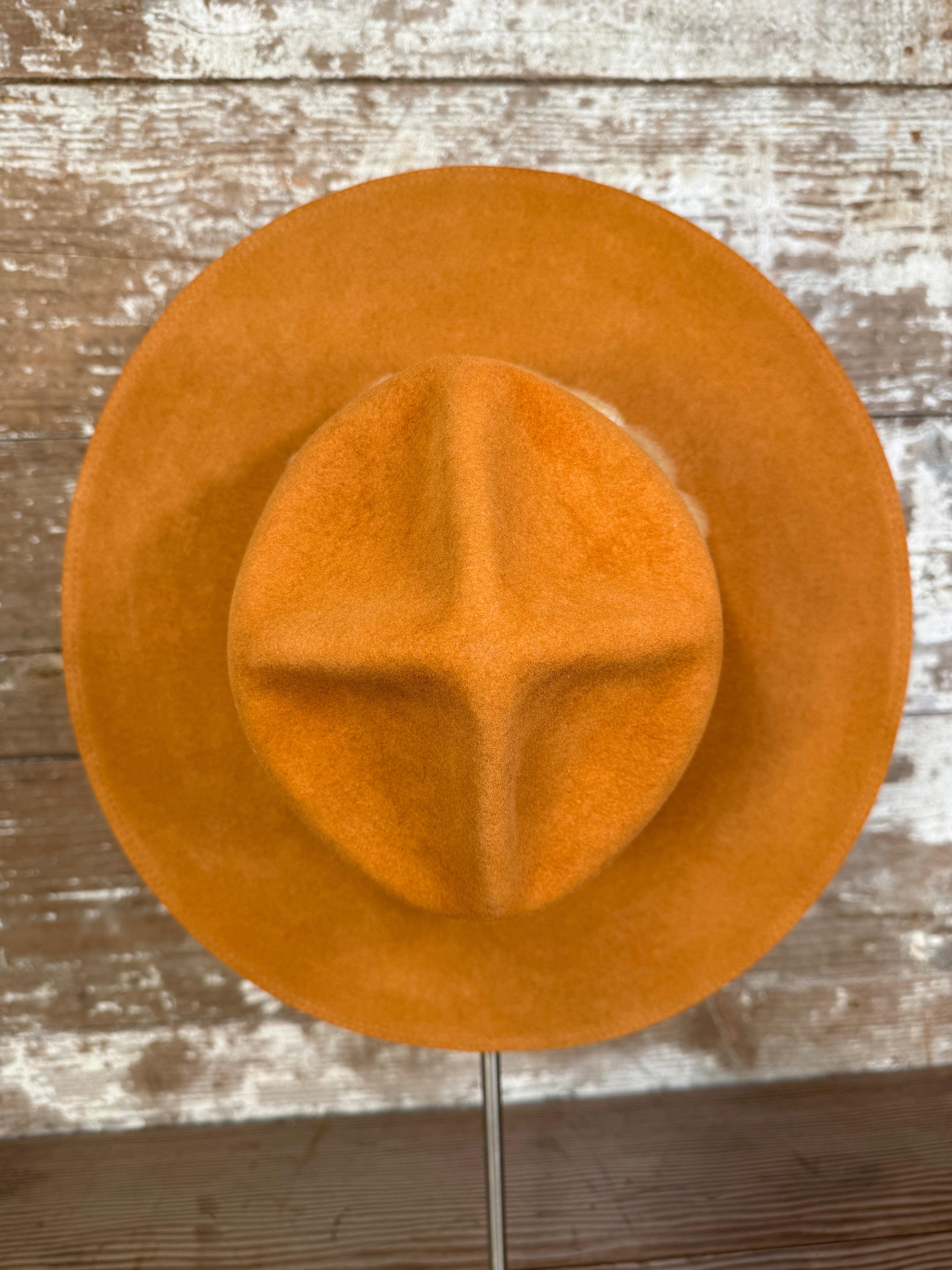 Top view of Solar Communion hand-shaped reclaimed beaver felt hat with denim-and-fur band and brass solar accent, handmade in Oregon