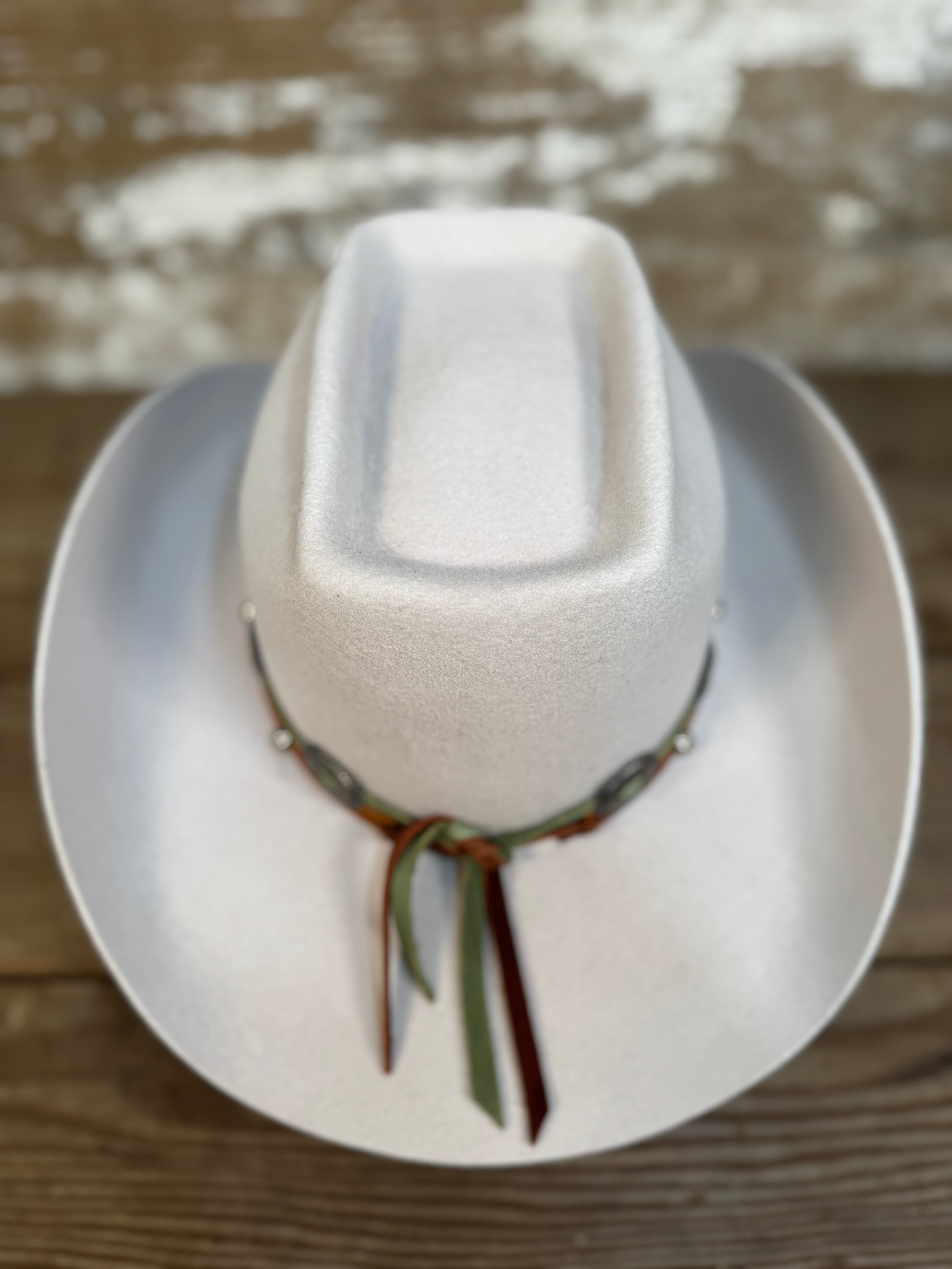 Back view of tan wool cowboy hat with a brick-style crown and come-and-go brim, finished with a smooth leather hat band and silver conchos.