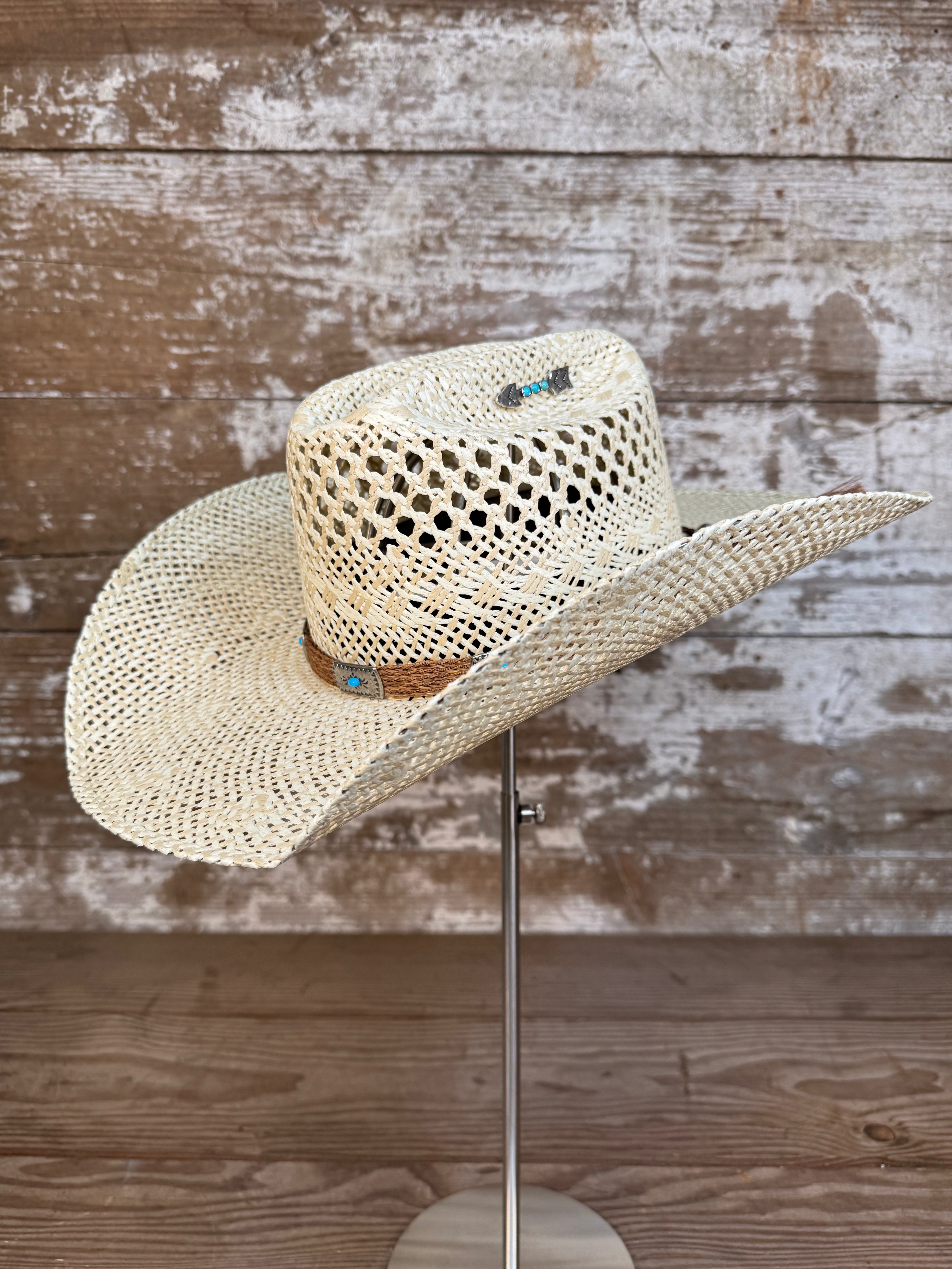 Side view of Wallowa Wind straw cowboy hat with horsehair band and silver arrow pin, handmade in Oregon