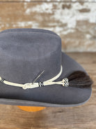 Detail view of Decent Trouble charcoal felt cowboy hat with rawhide band, tassel, and toothpick detail.