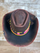 Top view of felt hat in deep red-brown with coffin crown, relaxed taco brim, Pendleton wool band, horsehair tie, Columbia Plateau sunburst beading, and vintage African trade beads.
