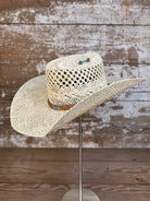 Side view of Wallowa Wind straw cowboy hat with horsehair band and silver arrow pin, handmade in Oregon